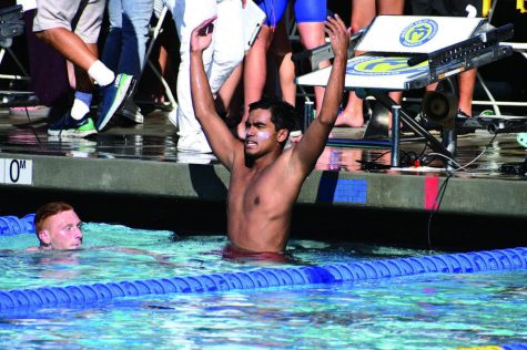 HANDS UP: Swimmer Ronald Dalmacio ’22 gestures to the sidelins after winning first place in the Division I 50-meter freestyle after swimming a 20.08-second race, winning by a margin of .25-seconds. Dalmacio lead the boys swimming and diving team to a 5-1 in Mission League competition.