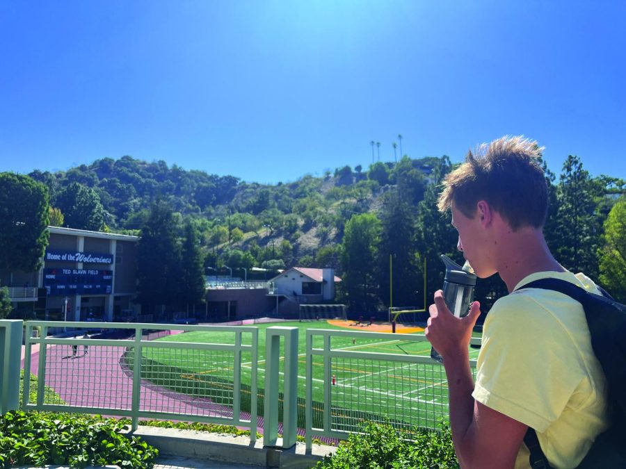 Franklin Wimbish ’25 looks across Ted Slavin Field, sipping water from his bottle as he endures the afternoon heat. Wimbish is a member of the school’s cross country team, which postponed its after-school practice to 6 p.m. on Sept. 16 in order to escape the heat. In addition to cross country, field hockey and girls tennis postponed their field practices.