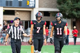 Walking out from the team locker room, Quarterback Henry Wendorf  ’23 and Wide Receiver Santiago 
Hernandez ’23 spark a conversation with a referee ahead of their 14-6 first season victory over Canyon High School on September 2. 