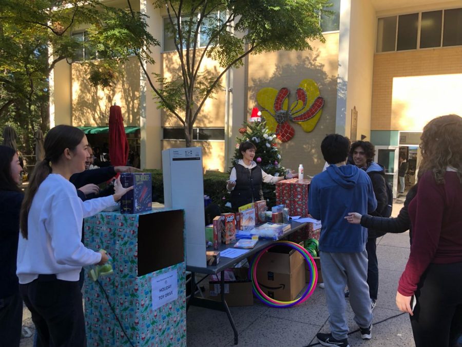 Gifts of Generosity: Members of Community Council stand by gift collection bins on the Quad. These bins were placed near the security kiosk at the main entrance, in the lounge and outside of the library.