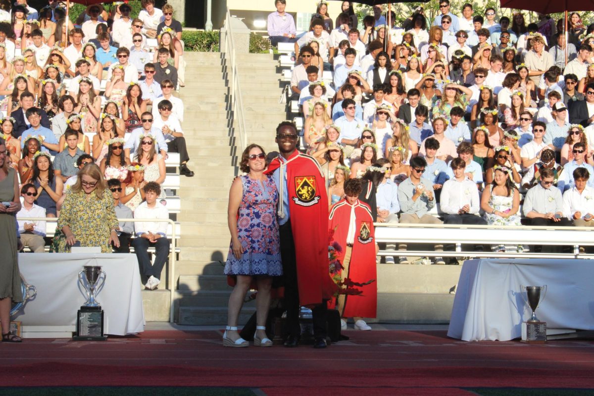 Head Prefect Bari LeBari 24 poses with Head of School Laura Ross for a picture after receiving his senior class ring during the annual Senior Ceremony.