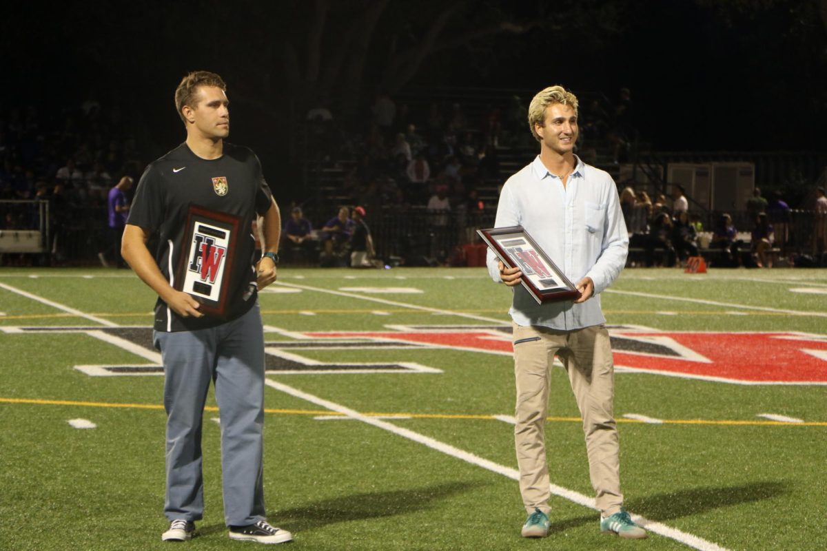 Felix+Brozyna-Vilim+17+and+Evan+Rosenfeld+17+receive+their+awards+on+the+field+during+Homecoming.+The+two+alumni+were+officially+inducted+into+the+Athletics+Hall+of+Fame+Oct.+7.