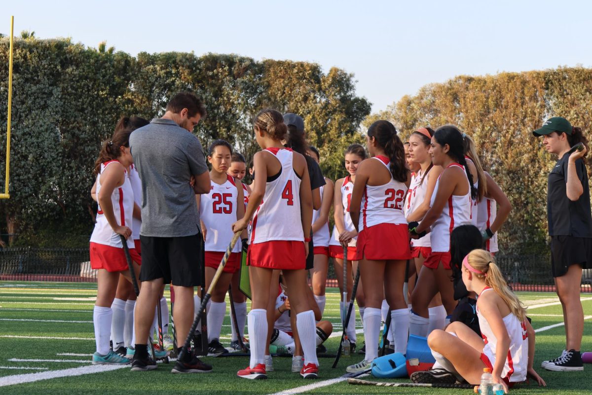 The field hockey team discusses strategy in a game against Great Oak High School Oct. 24. The team went on to win 3-1, advancing to the semifinal.