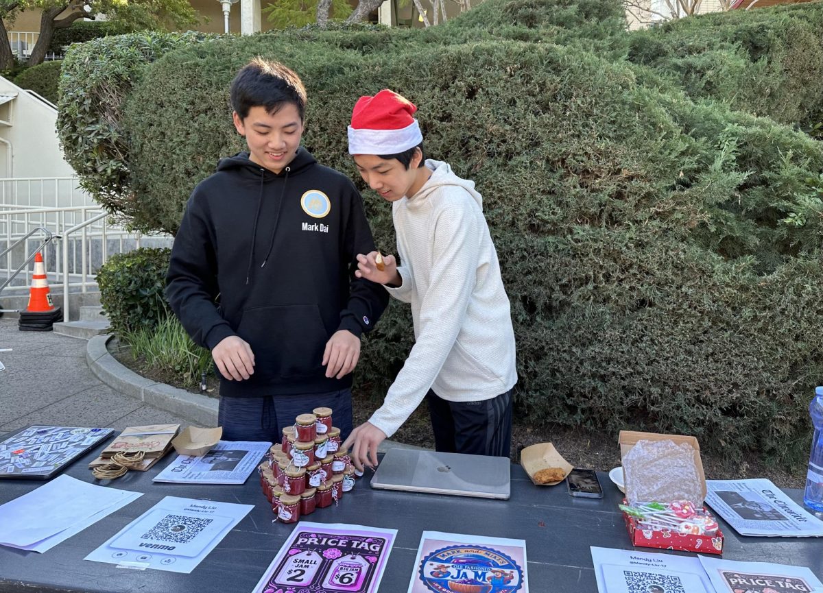Mark Dai ’26 and Mike Dai ’26 set up their booth Mark and Mikes Jams.