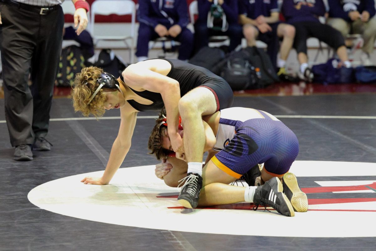 WRESTLING WINNERS: Adrian Drouin ’26, 144 pounds, fights to break free from his Chaminade opponents grip. The Wolverines and the Eagles held a match in the wrestling room Dec. 6, following the Downey 32 Way Tournament. The team will compete in the Tournament of Champions on Dec. 16.