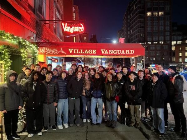 Jazz students stand together outside Village Vanguard, the oldest operating jazz club in New York City. It was opened in 1935 in Greenwich Village and has hosted renowned jazz musicians.