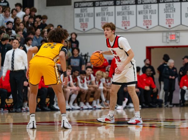 Senior guard Josh Engelberg 24 dribbles the ball up the court in the Mission League Championship Game against Crepsi Carmelite High School on Feb. 2.