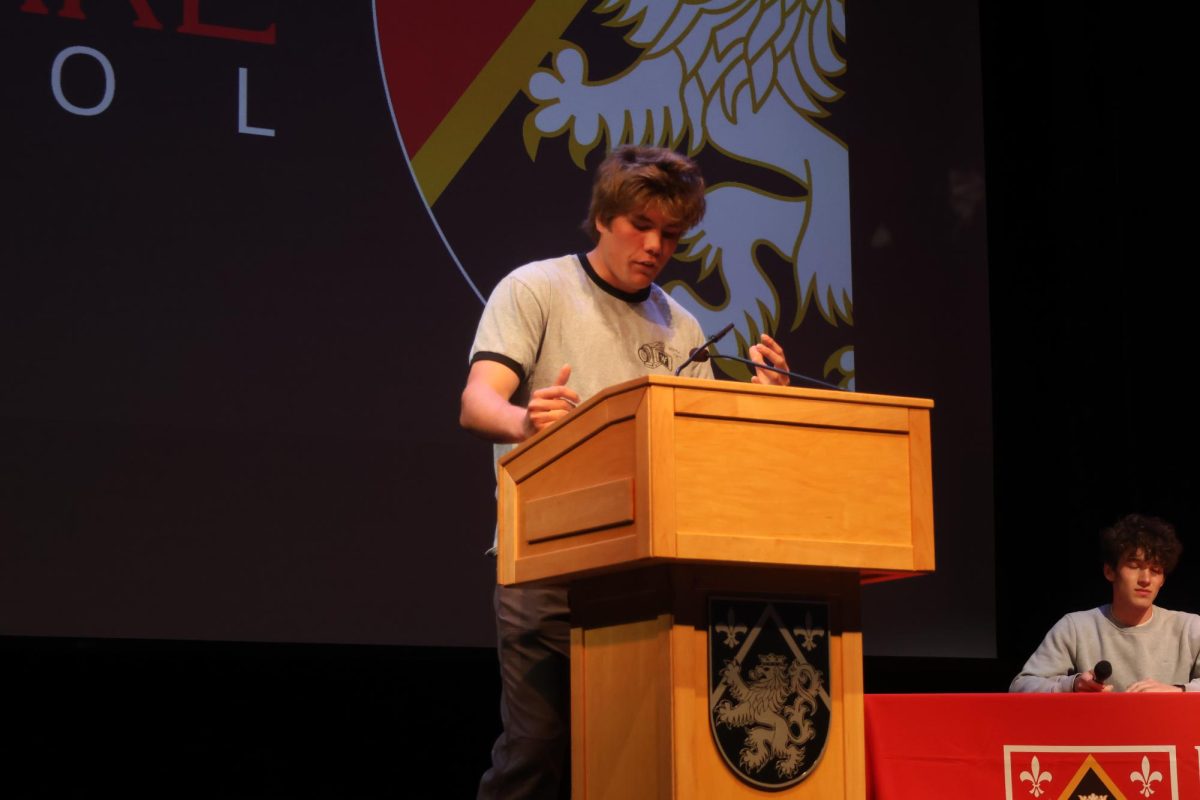 Junior Prefect Gideon Evans ’25 takes the stand for his introductory speech during the Preliminary Head Prefect Election round in Rugby Auditorium. This year, twelve candidates submitted statements and spoke in the Preliminary Election Round on March 13.