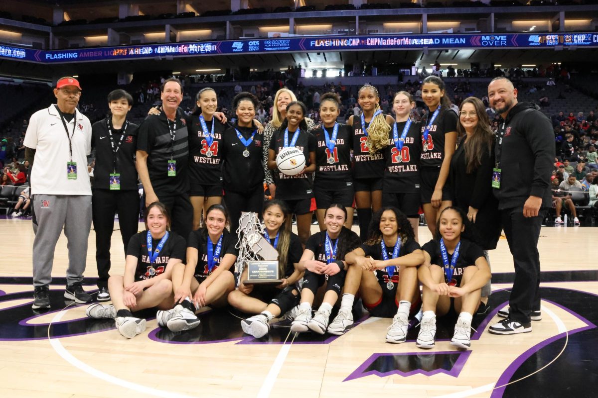 The girls basketball team poses center court with their medals and trophy after defeating Colfax High School 60-45 in the CIF Division 2 State Championship. The win is their first state championship since 2010, and marks Girls Program Head Melissa Hearlihys second state championship and 839th career win.