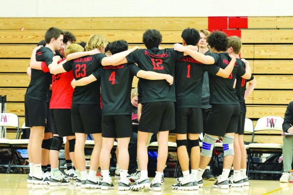 Boys’ volleyball huddles up during their game against Loyola High School on March 12. The team will face Crespi High School for an away game on March 21.