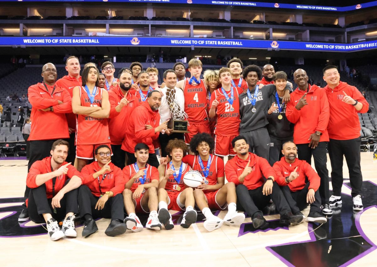 The boys basketball team poses at center court with the Open Division state title after defeating Salesian College Preparatory 50-45 at the Golden1 Center in Sacramento on Mar. 9.