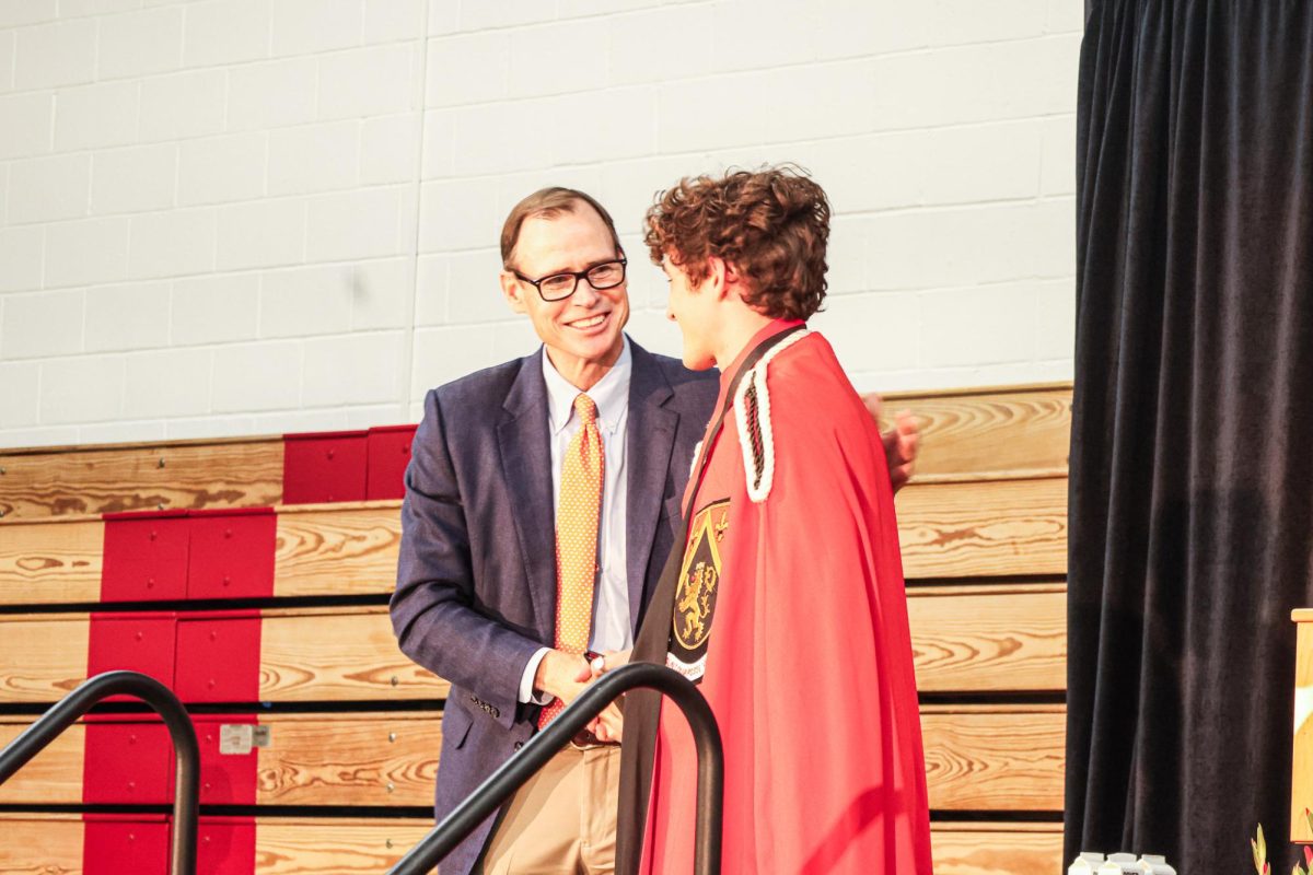 President of School Rick Commons presents Head Prefect Davis Marks 24 with the Humanitas award during the annual ceremony.