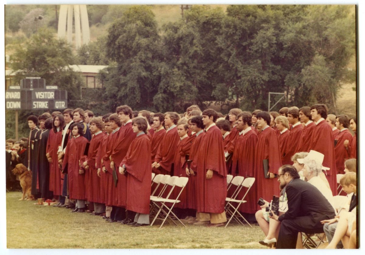 The Class of 1974 stands during their commencement ceremony.