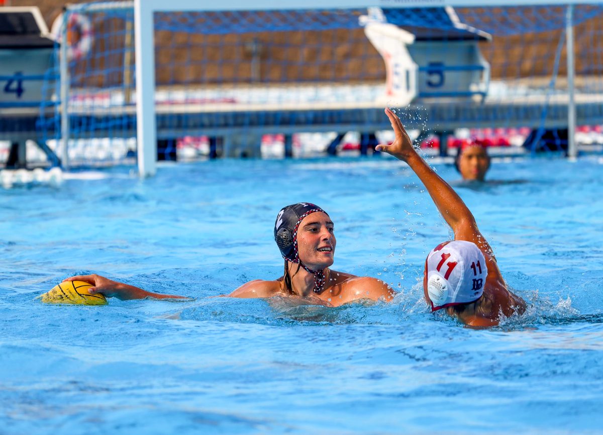 Taj Draper '25 controls the ball against a press from a Long Beach Wilson defender. He tallied a hat trick in the team's 18-15 win.