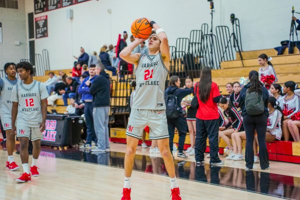 Guard Joe Sterling '26 shoots a three-pointer. The new transfer led the team with 25 points in the team's home-opener of the 2024-2025 season.