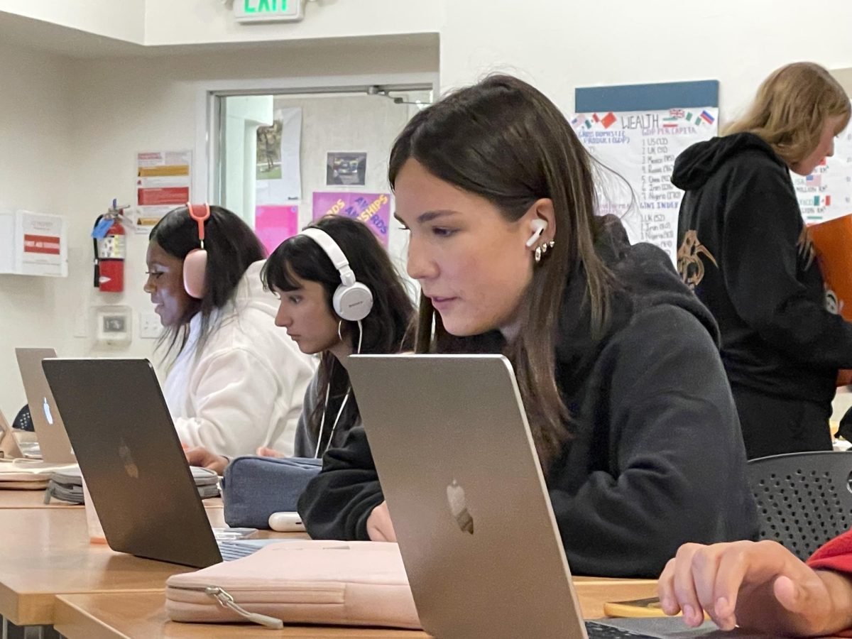 Harper Chihara Bibring '26, Anika Norton '26 and Michaela Williams '26 call voters during the phonathon.