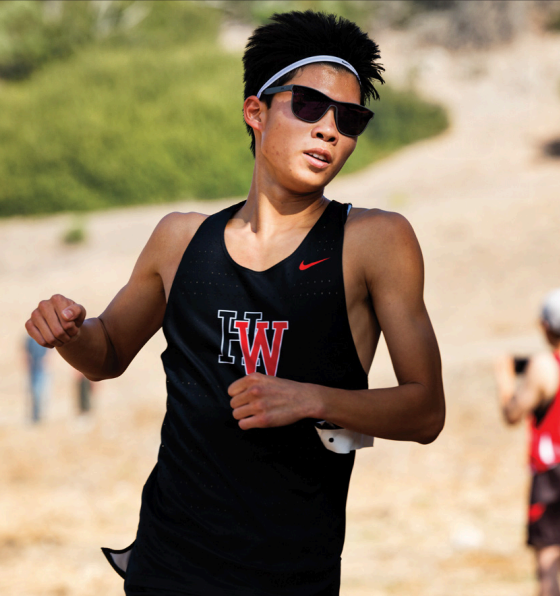 FINAL KICK: Robbie Louie ’26 nears the end of the two-mile race.