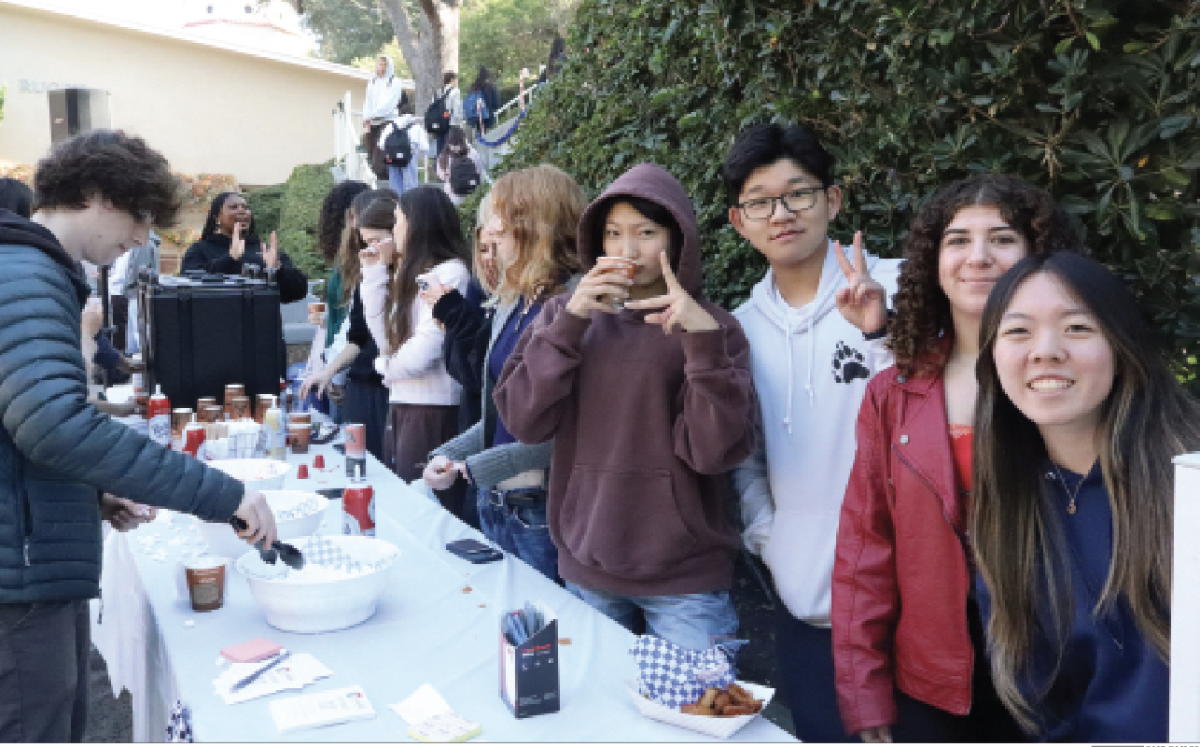 The Student Mental Health leaders pose for a picture on the Quad. They organized “How Full is Your Cup,” an event where students from all grades come together, share advice about how to cope with stress on Post-its and receive free cups of hot chocolate. 