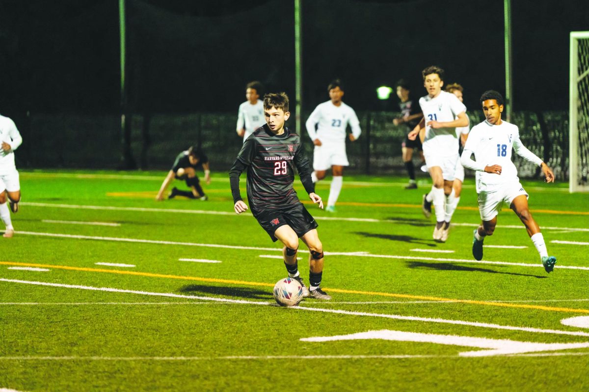 Lochlan Ripley ’26 controls the ball while he moves downfield during a match against Santa Monica High School. 