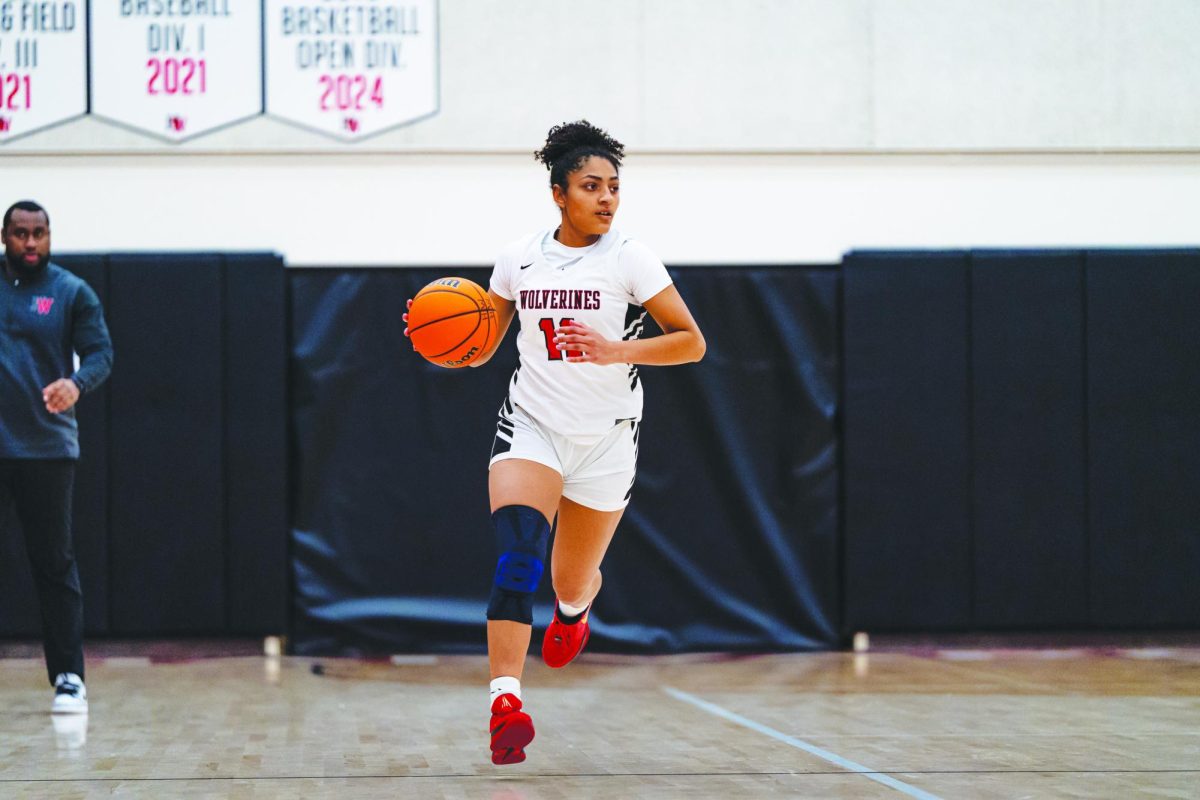 DETERMINED TO WIN: Deana Thompson ’25 drives down the court during a game against Chaminade. The team is preparing for postseason playoffs under their new head coach, Alex Nailes. Playoffs will begin Feb. 13.