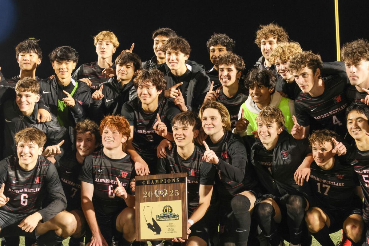 Team members and coaches hold up the CIF-SS Division 2 plaque after the team's 1-0 win against Jurupa Hills. The team's defense against the Spartans helped secure the victory.