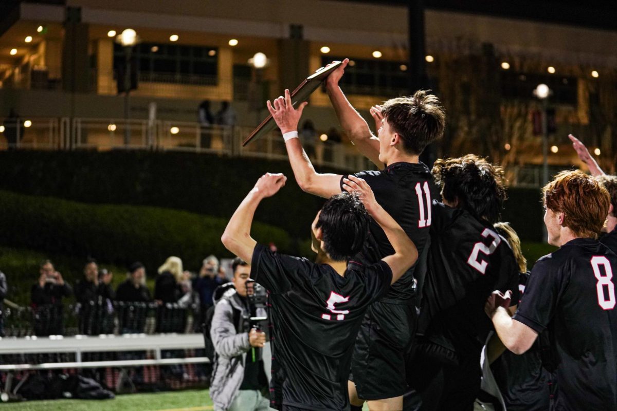 Theo Ottosson '25 lifts the Division 3 CIF Regionals plaque with his teammates after the game. He converted on a penalty shot and delivered an assist to Micah Rossen '25 for the team's second goal of the game.