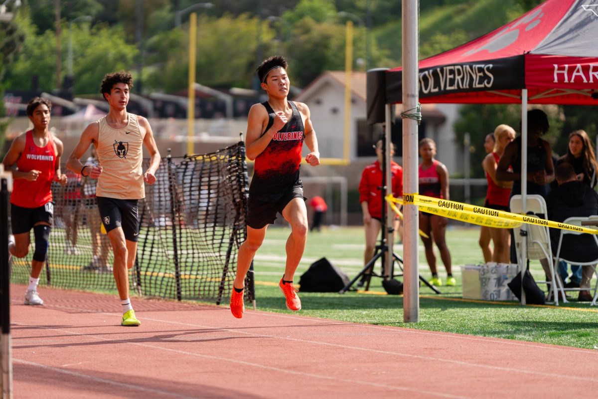 Robby Louie ’26 surges ahead on the track during a race at a home cross country meet. After a summer of training, 
Louie is sharpening his consistency, maintaining pace through the final stretch and contributing to the team’s momentum this season.