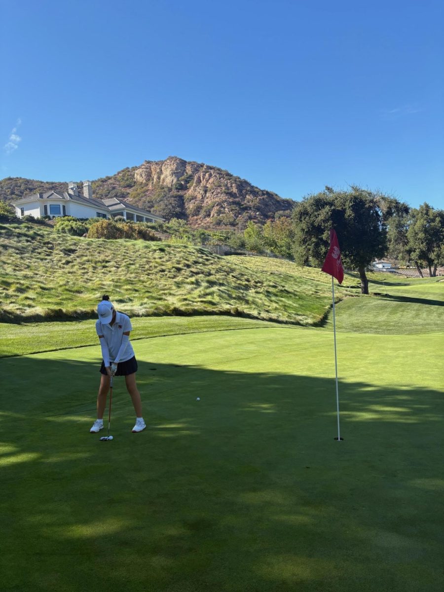 Layout Assistant and Staff Writer Katelyn Kim ’28 lines up her ball and gets ready to putt at Lakewood Country