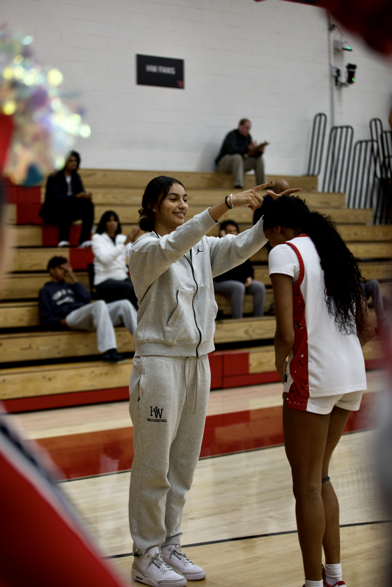 Valentina ’29 crowns Oyinkan Iriafen ’27 in their pregame handshake.