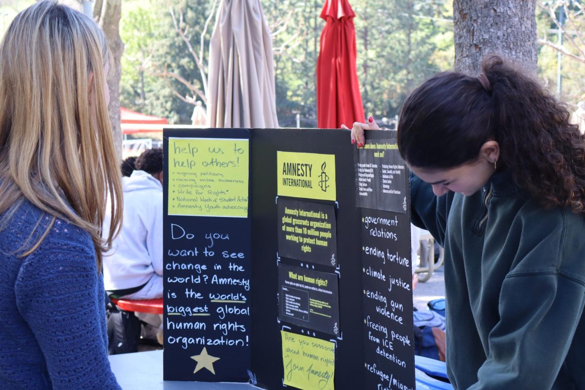 Amnesty International Club Leader Lulu Aridi ’27 (right) encourages students to get involved with the school’s chapter of the organization.
