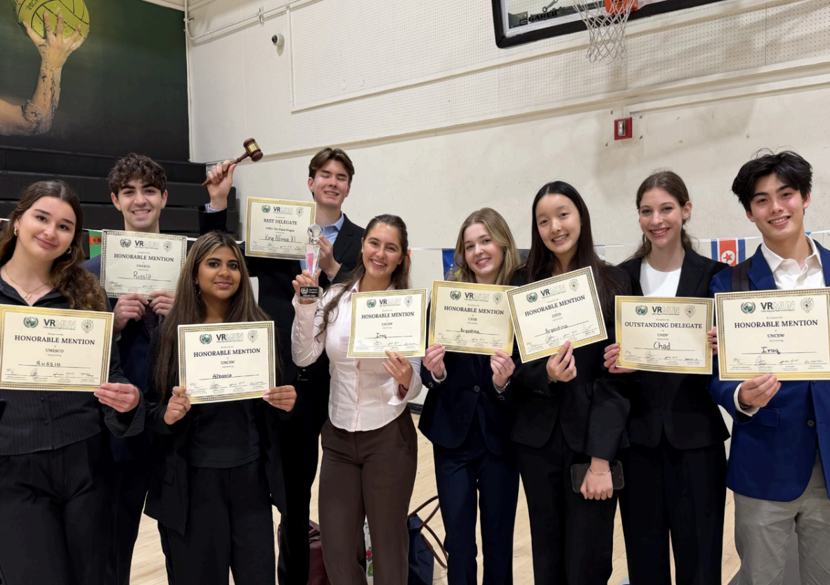 Students of the school's Model United Nations team pose for a photo holding awards
