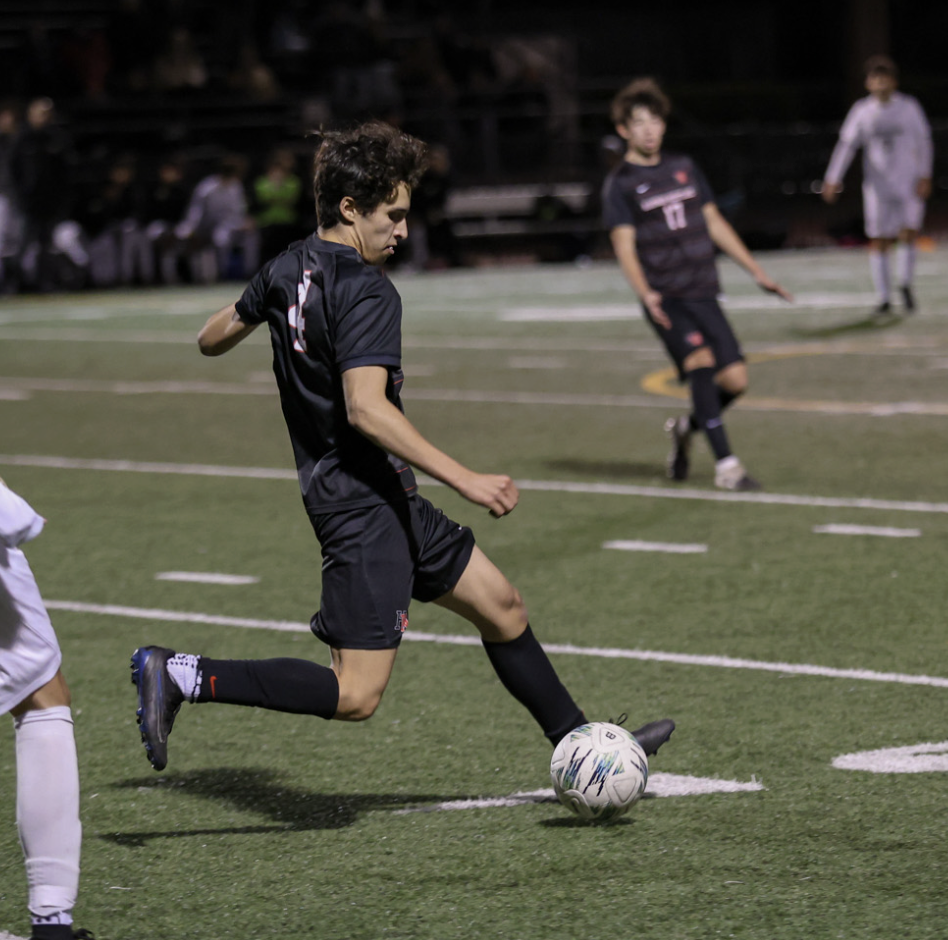 Midfielder Jack Lee '27 sets up a long-range pass against tight defensive coverage in a 2-0 win against Notre Dame.