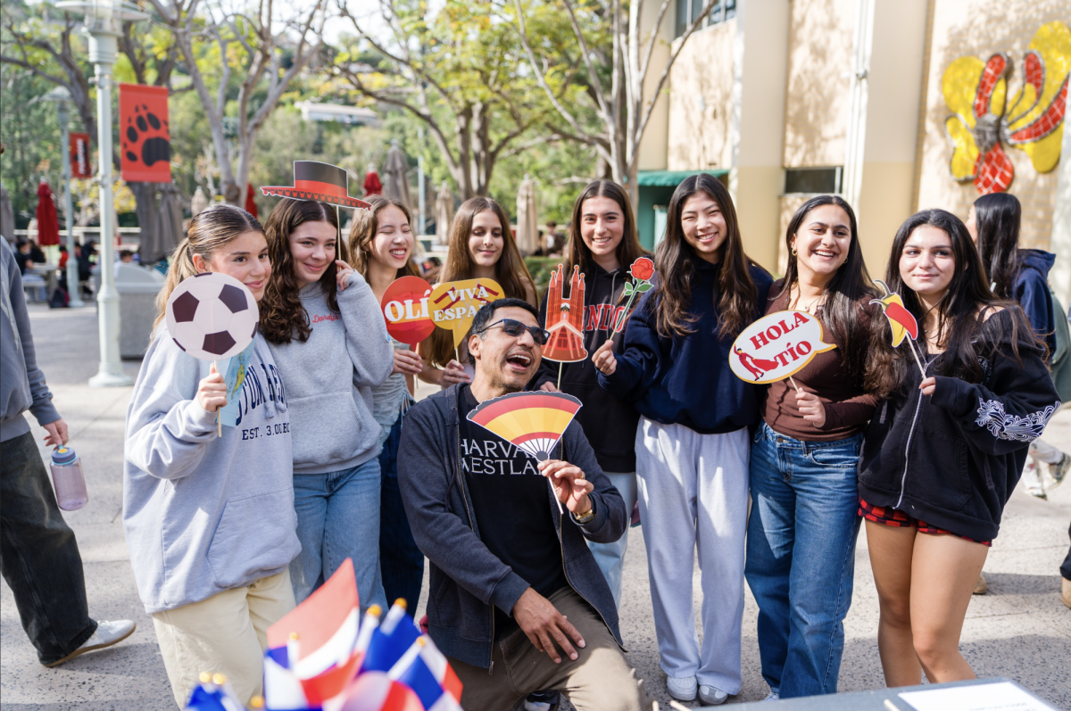 Students celebrate language and culture in the Quad during the annual World Language Week by posing with Spanish-themed photobooth props.